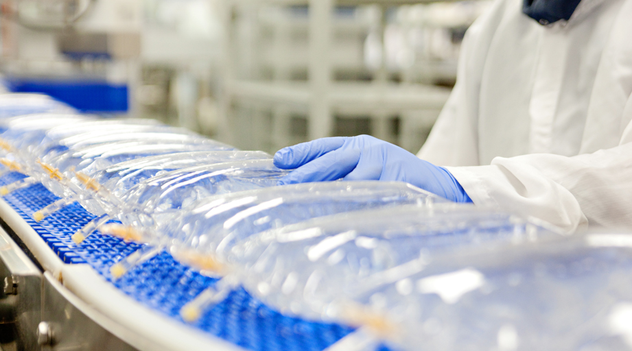 IV fluid bags on a conveyor belt